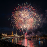 Multicolored fireworks above Dresden’s riverfront with reflections on the Elbe River